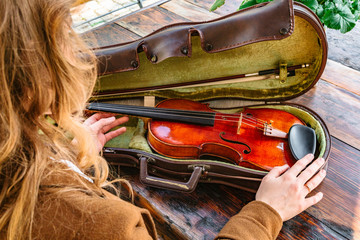 Womans hands with violin and case for violin