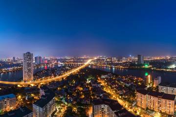 Fototapeta na wymiar Aerial skyline view of Hanoi at Linh Dam lake, Belt Road No. 3. Hanoi cityscape by sunset period