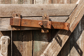 Retro copper door bolt. Old wooden door.  Wooden background