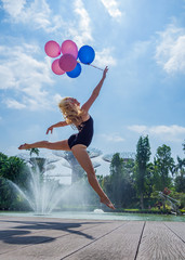 Fototapeta na wymiar Dancer with baloons jumping