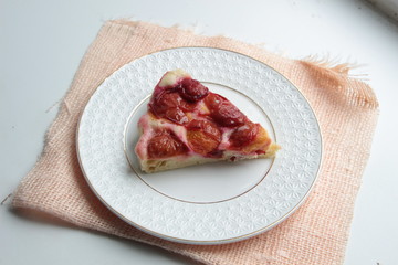 Slice of plum cake on plate with background