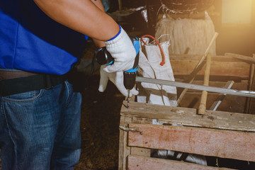 construction man workers in blue shirt with Protective gloves and working with power drill