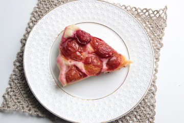 Slice of plum cake on plate with background
