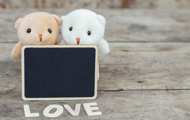 Brown and white teddy bears with black wood tag and LOVE letter