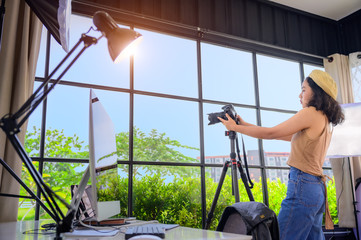 woman freelance photographer and blogger working individual at own office studio