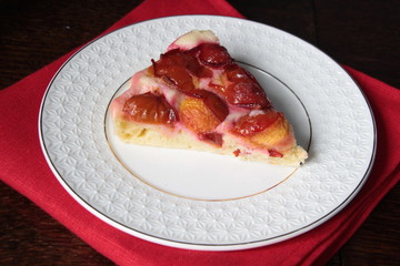 Slice of plum cake on plate with background