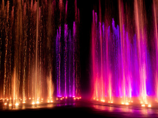Fototapeta na wymiar colored decorative dancing water jet led light fountain show at night