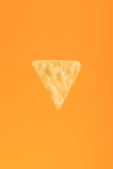 top view of crispy corn nacho isolated on orange, Mexican cuisine