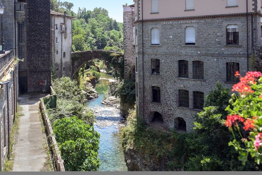 Magra River with the ancient bridge between the houses of Bagnone, a beautiful ancient town in Tuscany, Italy