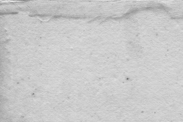 Cardboard white texture close-up. Light old paper background. Grunge concrete wall. Vintage blank wallpaper.