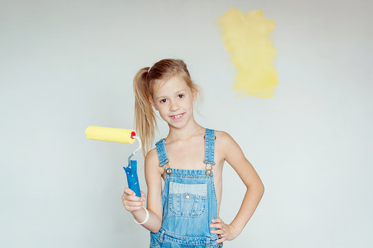little girl paints the walls yellow