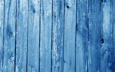 Fototapeta premium Weathered wooden fence in navy blue color.