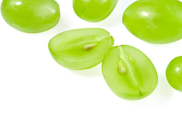 Fresh green grapes isolated on white background. Ripe grapes cut in half.