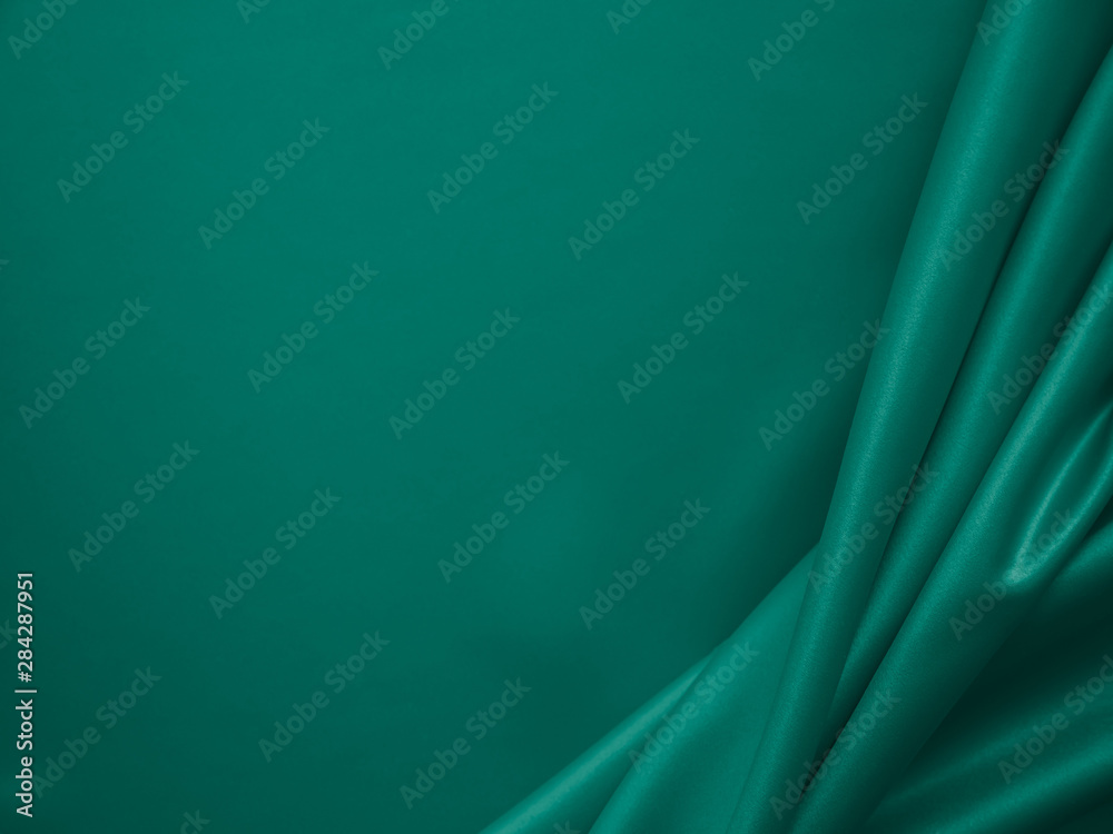 Wall mural beautiful smooth elegant wavy emerald green satin silk luxury cloth fabric texture, abstract backgro