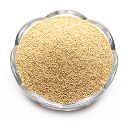 Amaranth seeds in glass bowl isolated on white background