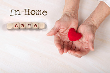 Words IN-HOME CARE composed of wooden dices.