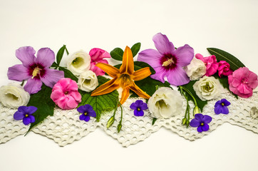 White background with an openwork border,located in the middle,is covered with heads of flowers of...