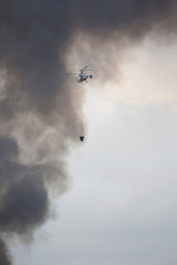 Helicopter of State Emergency Service is bringing the water in the bucket