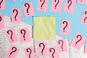 Scribbled and crumbling papers with thick cardboard above wooden table.