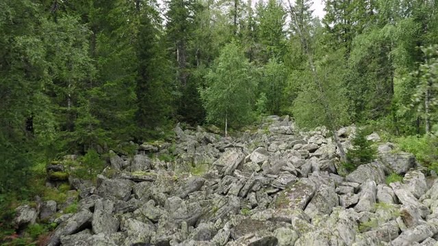 aerial view of Taganay national park in Russia. drone flying over big stone river - amazing and impressive natural formation. wonder of nature is an evenly conglomeration of huge rocky flinders