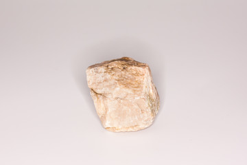 Natural beige stone isolated on white background