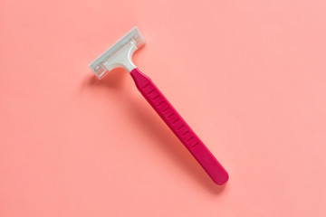 Disposable shaving machine for women on a pink pastel background, flatley, copy space.