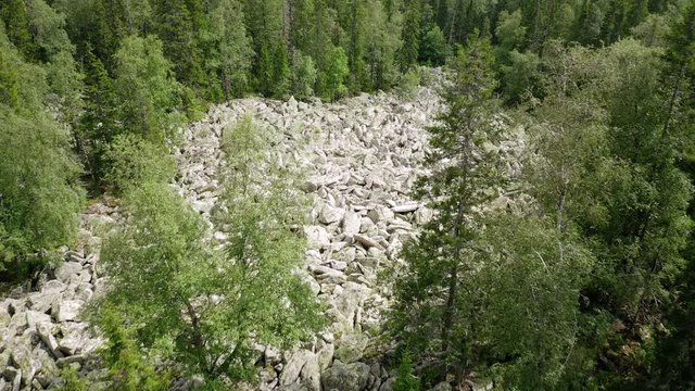 aerial view of Taganay national park in Russia. drone flying over big stone river - amazing and impressive natural formation. wonder of nature is an evenly conglomeration of huge rocky flinders