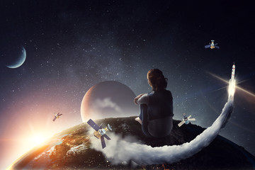 Young woman in casual clothes sitting and hugging knees