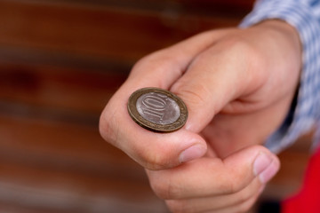 close up shot of hand toss a coin, probable and winning chances concept, fifty-fifty