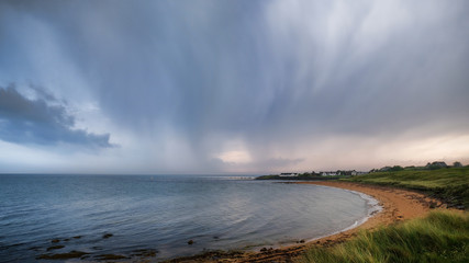 Thundery skies over Brora beach in Sutherland in the Highlands of Scotland