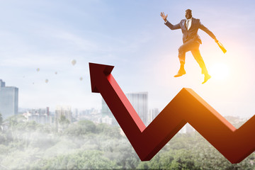 Black businessman running on red zigzag increasing arrow