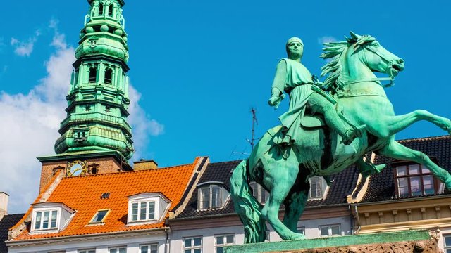 Copenhagen, Denmark. Vie wof Bishop Absalon statue and Nikolaj Copenhagen Contemporary Art Center in Copenhagen, Denmark. Time-lapse during a sunny summer day with clouds in the blue sky, pan video