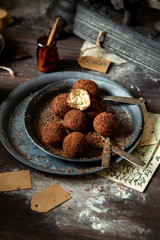 homemade truffle candy in two metal vintage plates with chocolate flakes