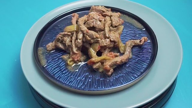 Beef fajitas in blue plate rotating