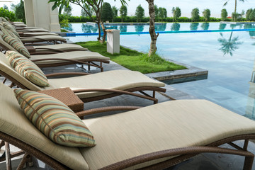 Deck chairs by the pool in resort