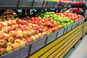 Fresh healthy fruits on shelves in supermarket