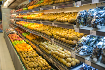 Fresh healthy fruits on shelves in supermarket