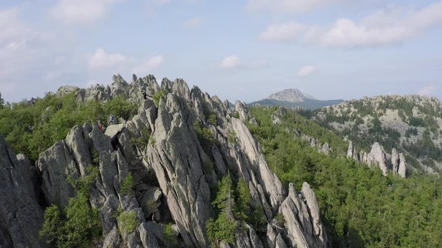 aerial view of ural nature. drone flying over the steep stony slope with coniferous and deciduous mixed forest at the foot of mountain. natiounal park, ecological protected area in Russia