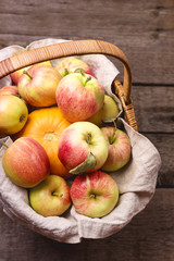 Basket of Fresh Ripe Apple and Pumpkin on Old Wooden Background Harvest Concept Autumn Fruits Vertical Top View
