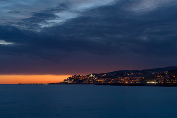 Clouds of contrasting color over the evening city