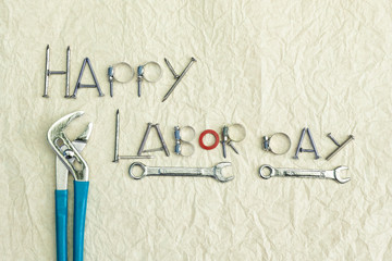 Happy Labor day sign, spare part arrange in world with tools on blank wrinkle paper background