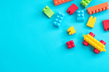 Plastic toy blocks on blue background