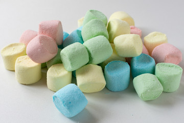 Colored marshmallows on a white background. A closeup of colored marshmallows.