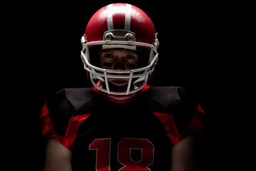 American football player standing with rugby helmet