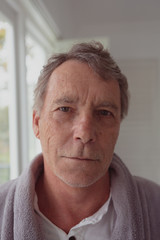 Active senior man looking at camera in a comfortable home