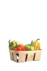 basket of sweet peppers isolated on white background