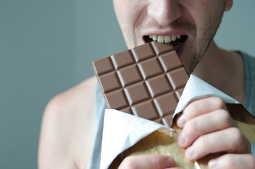 man holding and eating  chocolate