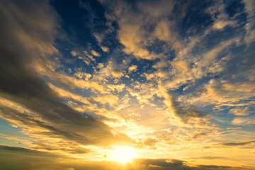 Dramadic Sunset Sky blue and orange light of the sun through the clouds in the sky