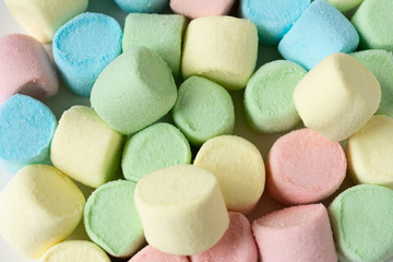 Colored marshmallows on a white background. A closeup of colored marshmallows.