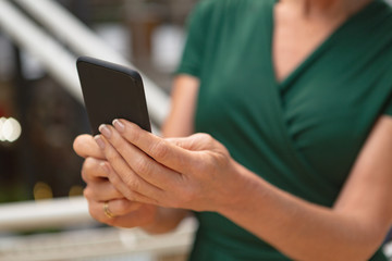 Businesswoman using mobile phone in the corridor at office